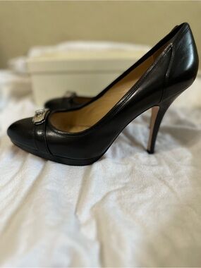 Coach black leather platform pumps with the signature Coach turn-lock hardware a